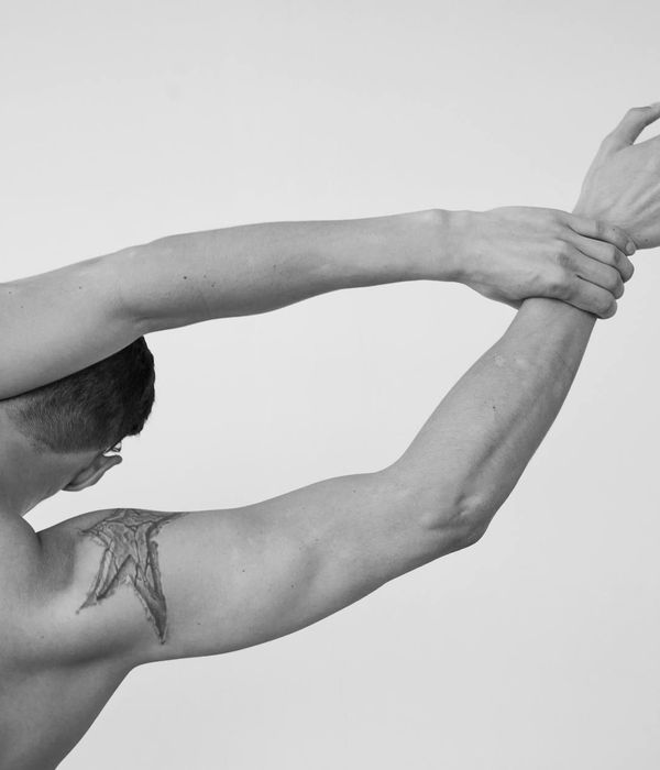Man performing a controlled strength exercise in a minimalist gym.